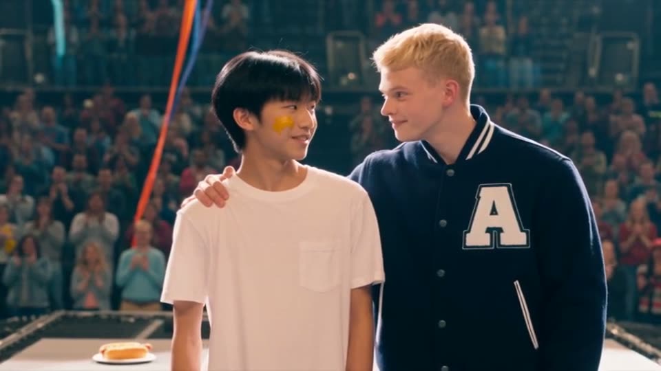 Clip 9: the quarterback in a varsity jacket puts a hand on Mike's shoulder in the arena
